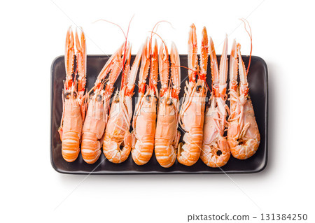 Scampi langoustine on plate isolated on white background. Scampi langoustine on plate isolated on white background. 131384250