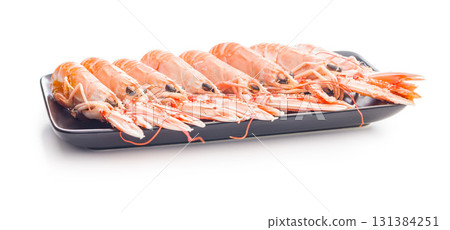 Scampi langoustine on plate isolated on white background. Scampi langoustine on plate isolated on white background. 131384251