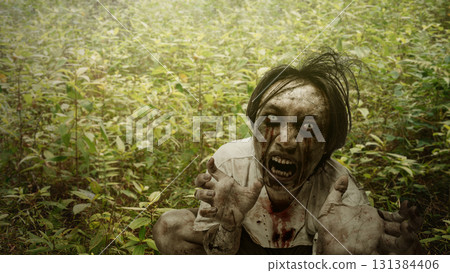 Scary male zombie with a wound and bloody hide under the bush in the haunted forest. The scene is scary and creepy. Dramatic smoke or fog effect. Concept of Spooky Halloween 131384406