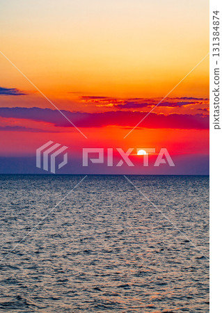 setting sun over sea at sunset setting sun over sea at sunset 131384874