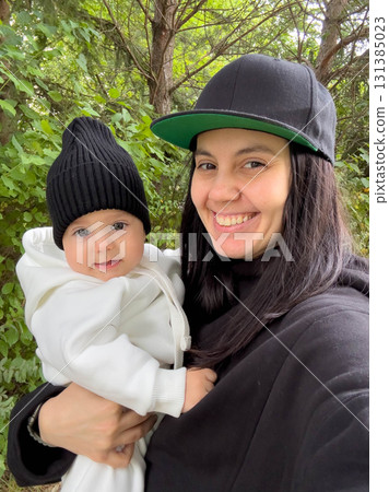 Mother Kissing Baby in Forest 131385023