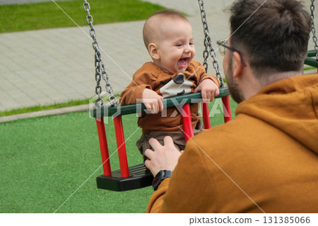 Father and Baby Enjoying Swing Time Father and Baby Enjoying Swing Time 131385066