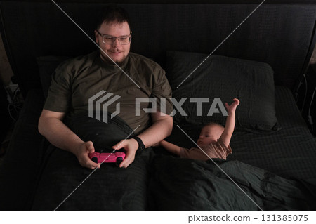 Father and Baby Bonding Over Video Games 131385075