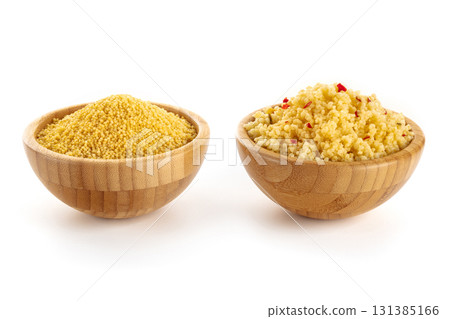 Millet, ancient African grain, dry and cooked, in wooden bowls on white Millet, ancient African grain, dry and cooked, in wooden bowls on white 131385166