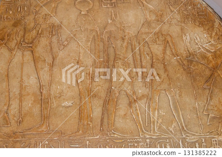 Ancient egyptian paintings and hieroglyphs carved on the stone wall Ancient egyptian paintings and hieroglyphs carved on the stone wall 131385222