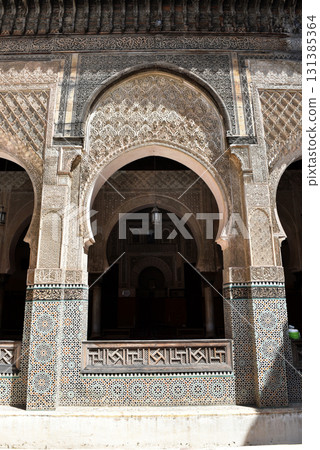 Carved stone gate arch, carved wooden archtectural details, Medersa bou Inania, Fez, Morocco 131385364