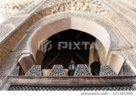 Carved stone gate arch, carved wooden archtectural details, Medersa bou Inania, Fez, Morocco Carved stone gate arch, carved wooden archtectural details, Medersa bou Inania, Fez, Morocco 131385366