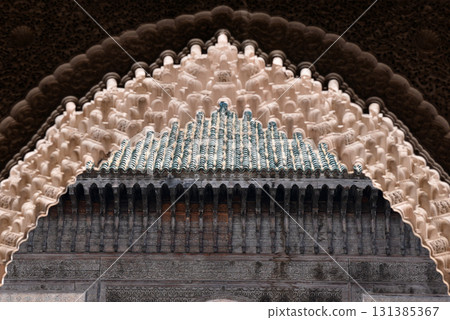 Carved stone gate arch, carved wooden archtectural details, Medersa bou Inania, Fez, Morocco Carved stone gate arch, carved wooden archtectural details, Medersa bou Inania, Fez, Morocco 131385367