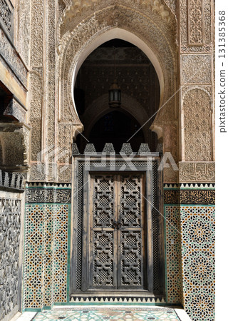 Carved stone gate arch, carved wooden archtectural details, Medersa bou Inania, Fez, Morocco Carved stone gate arch, carved wooden archtectural details, Medersa bou Inania, Fez, Morocco 131385368