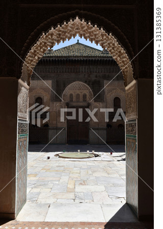 Carved stone gate arch, carved wooden archtectural details, Medersa bou Inania, Fez, Morocco 131385369