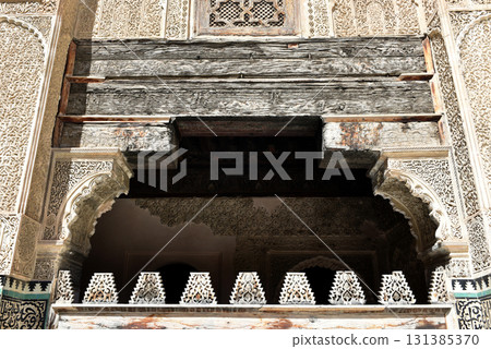 Carved stone gate arch, carved wooden archtectural details, Medersa bou Inania, Fez, Morocco Carved stone gate arch, carved wooden archtectural details, Medersa bou Inania, Fez, Morocco 131385370