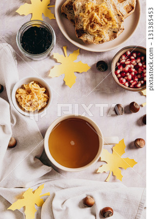 A cup of tea and autumn toast with apple jam on a plate on the table top and vertical view 131385453