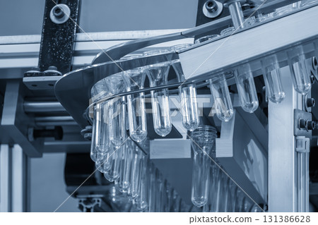 Close up scene the plastic bottle preform shape on the conveyor belt in the blue scene Close up scene the plastic bottle preform shape on the conveyor belt in the blue scene 131386628