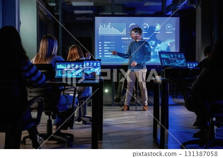 Smart coach. Male business trainer is against projector with data, teaching people Smart coach. Male business trainer is against projector with data, teaching people 131387058