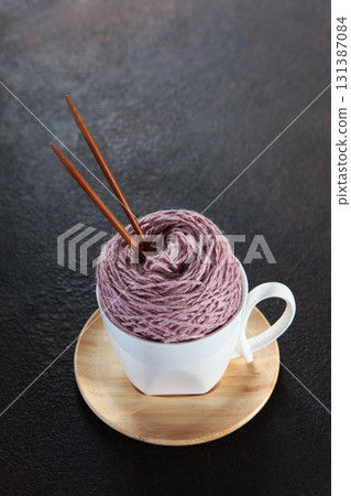 Yarn made from pure wool for knitting. Ball of yarn in cup. Concept of hobbies and handicrafts. Yarn made from pure wool for knitting. Ball of yarn in cup. Concept of hobbies and handicrafts. 131387084