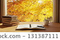Books and coffee cups on a wooden desk in an autumn atmosphere 131387111