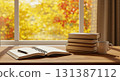 Books and coffee cups on a wooden desk in an autumn atmosphere 131387112