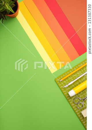 Workspace for paper crafts. Colored sheets, cutting mat, pencil, knife, eraser. Space for text. Workspace for paper crafts. Colored sheets, cutting mat, pencil, knife, eraser. Space for text. 131387330