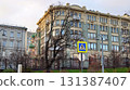 A large building and a tree next to it. 131387407