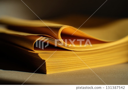 Close-up of curled yellow legal paper stack shows smooth stationery texture and bright folds, ideal for office, legal, or educational content 131387542