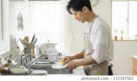 Husband washing dishes 131387567