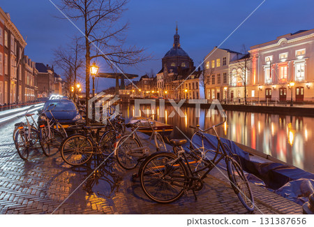 Canal with bikes at night in Leiden Netherlands 131387656