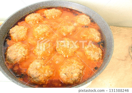 Meatballs in red tomato sauce cooking in a pan 131388246