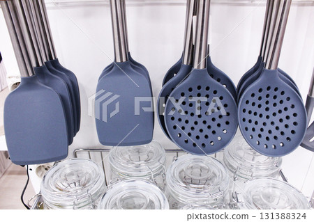 plastic blades and gray slotted spoons close-up. Kitchen Set Accessories plastic blades and gray slotted spoons close-up. Kitchen Set Accessories 131388324