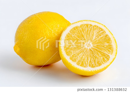 A bright yellow lemon fruit is sliced in half, revealing its juicy interior. 131388632