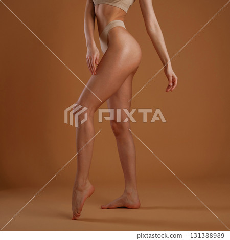 Close up view. Woman with slim body shape is posing against background Close up view. Woman with slim body shape is posing against background 131388989