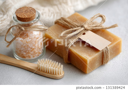Natural soap bar, wooden toothbrush, and glass jar with salt in zero waste bathroom concept 131389424