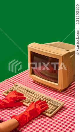 Hands in red gloves typing on the keyboard of a retro computer 131390190