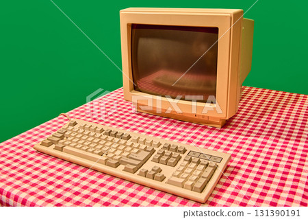 Retro beige computer monitor and keyboard on checkered table Retro beige computer monitor and keyboard on checkered table 131390191