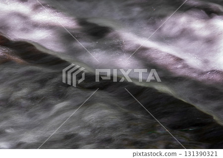 Babbling stream flowing through rocks 131390321