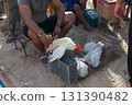 Cage with hens at Douz livestock market, Tunisia. Unrecognizable peopleck market, Tunisia 131390482