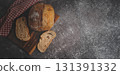 Rustic sourdough bread loaf with slices on wooden board 131391332