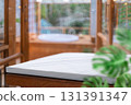 White stone counter with blurred jacuzzi and greenery 131391347
