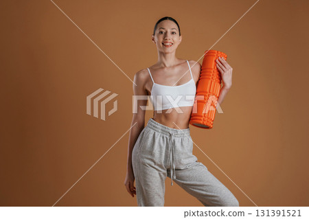 Ready for the practice, standing. Beautiful fitness woman is in the studio 131391521