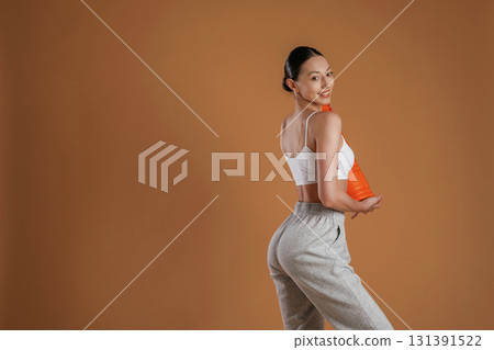 Ready for the practice, standing. Beautiful fitness woman is in the studio Ready for the practice, standing. Beautiful fitness woman is in the studio 131391522