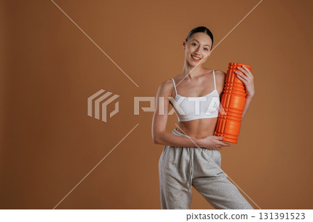 Ready for the practice, standing. Beautiful fitness woman is in the studio 131391523