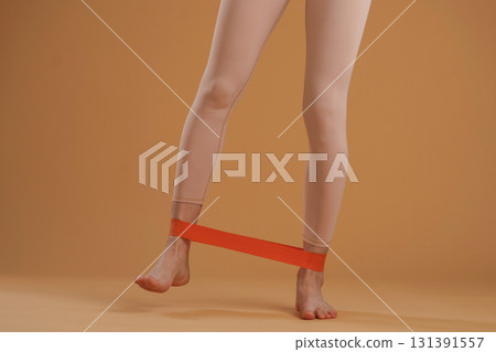 Legs of fitness woman that is in the studio, doing stretching 131391557