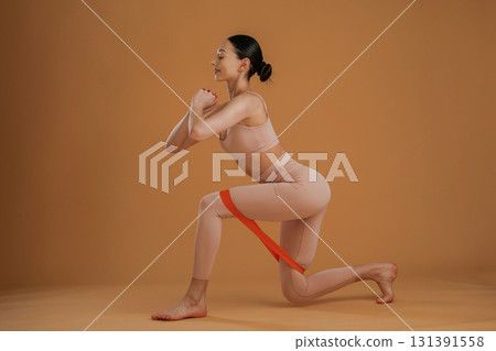 Doing squats. Beautiful fitness woman is in the studio 131391558