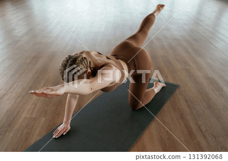 Yoga asana. Fitness woman in sportswear is indoors 131392068