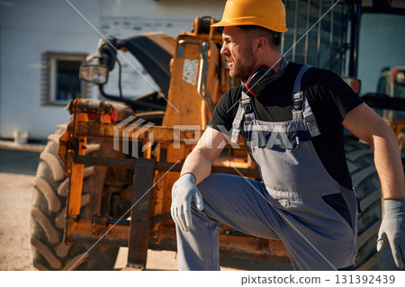 Man is with tractor. Agricultural worker 131392439