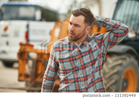 Man is with tractor. Agricultural worker Man is with tractor. Agricultural worker 131392449