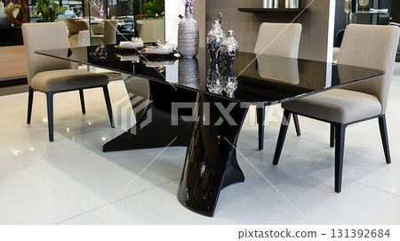 Black table with a white chair is in the foreground 131392684