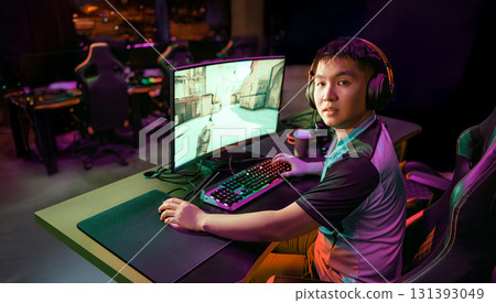 A Focused Gamer Eagerly Competing in the Thrilling ESports Arena for Glory and Fun A Focused Gamer Eagerly Competing in the Thrilling ESports Arena for Glory and Fun 131393049