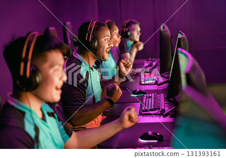 Excited Gamers Celebrating Their Team Victory in a Thrilling ESports Arena Environment Excited Gamers Celebrating Their Team Victory in a Thrilling ESports Arena Environment 131393161
