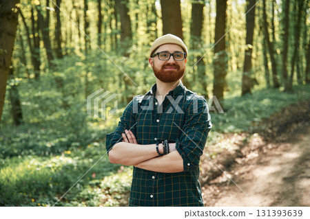 Front view. Bearded man is in the forest at daytime Front view. Bearded man is in the forest at daytime 131393639