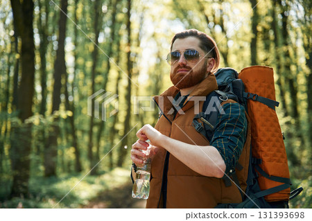 Enjoying warm weather and nature. Bearded man is in the forest at daytime Enjoying warm weather and nature. Bearded man is in the forest at daytime 131393698